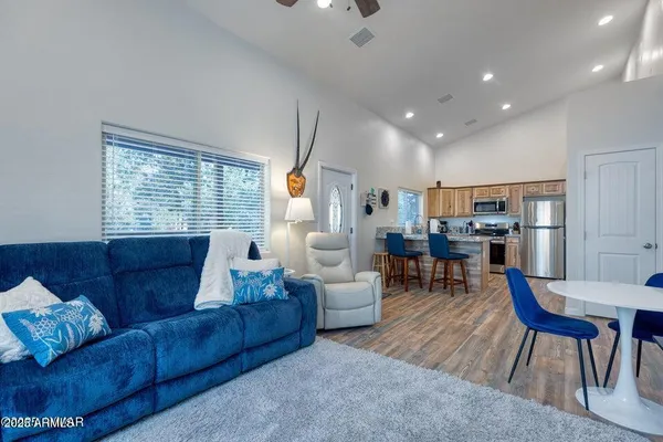 a kitchen with a table chairs refrigerator and cabinets