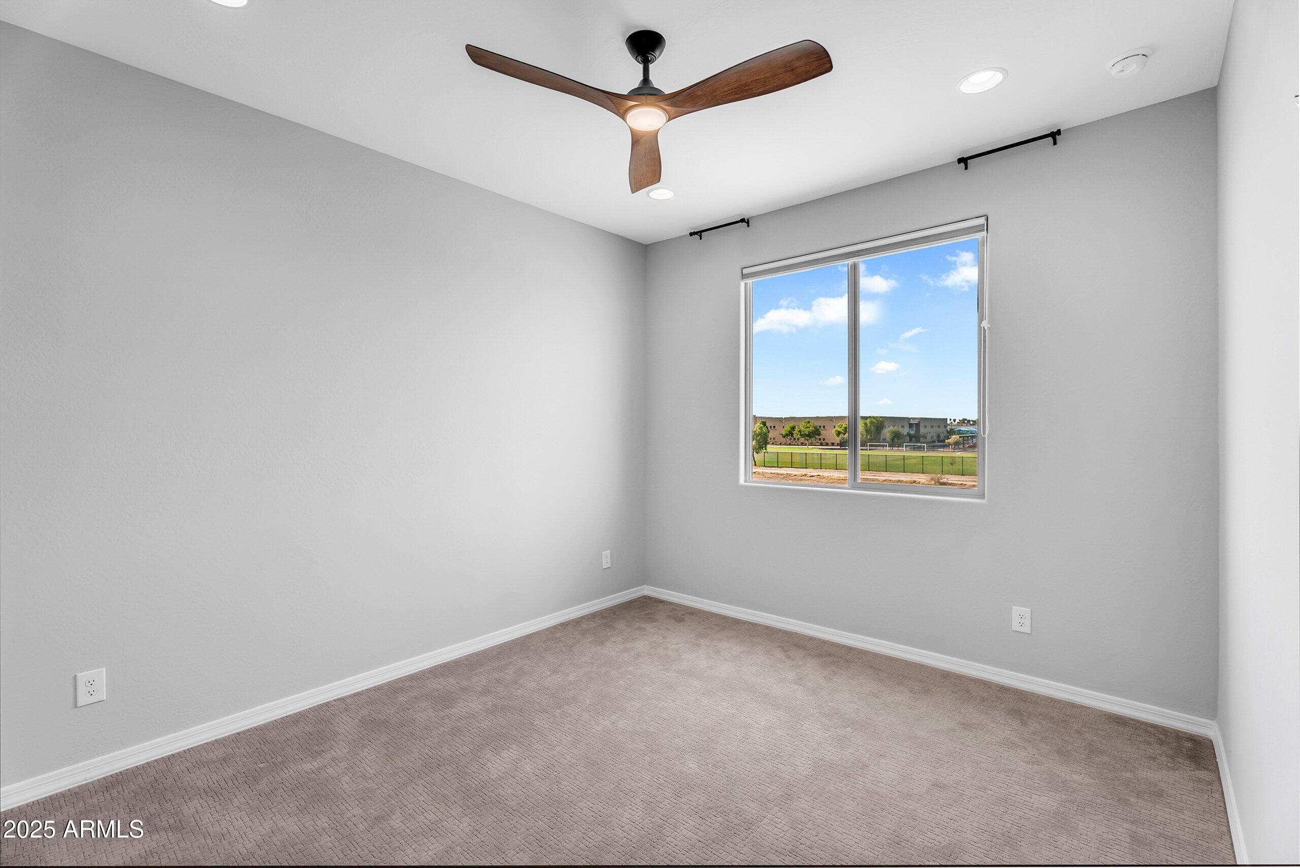 6732 West Coles Road Laveen, AZ 85339 - Photo 25 of 41 an empty room with a window and a ceiling fan