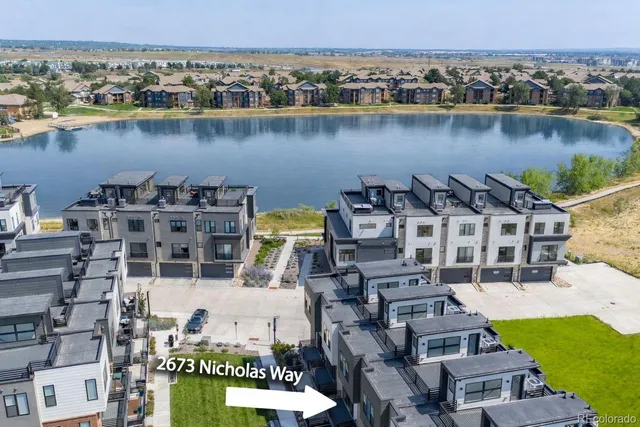 an aerial view of a house with a lake view