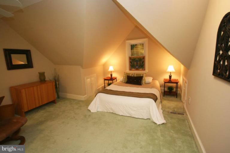 9220 Whitney Street Silver Spring, MD 20901 - Photo 17 of 30 a spacious bedroom with a bed and a couch