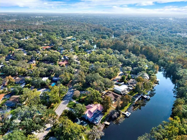 an aerial view of residential house with outdoor space and lake view