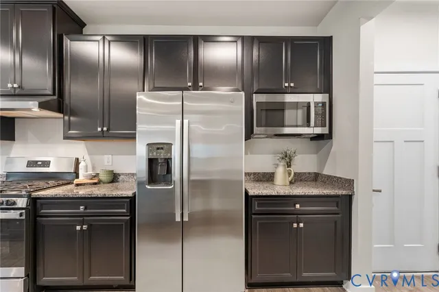 a kitchen with a refrigerator sink and microwave