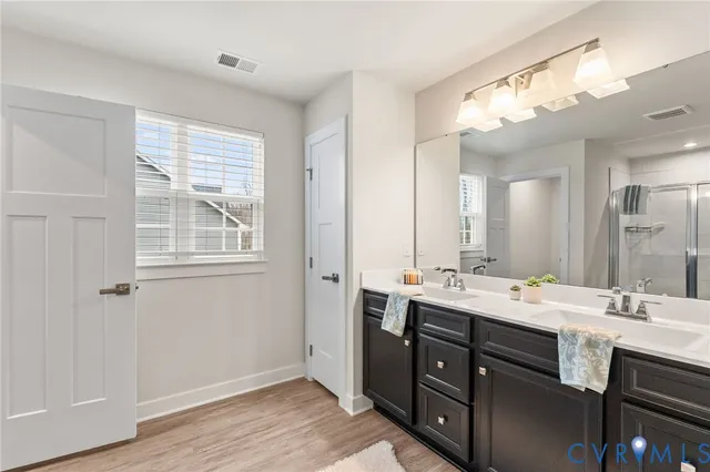 a bathroom with a sink double vanity and a mirror