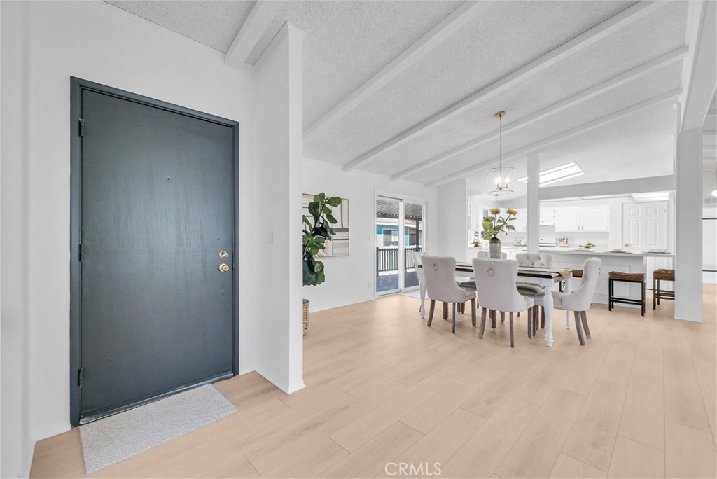 21650 Temescal Canyon Road, Unit 26 Corona, CA 92883 - Photo 12 of 32 a dining room with furniture and a kitchen view