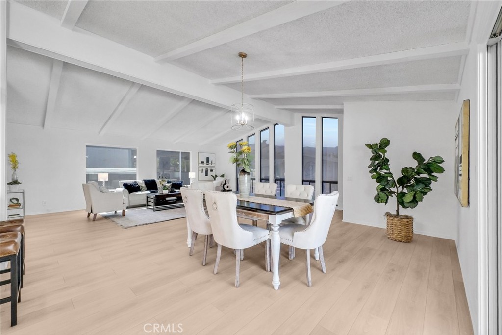 21650 Temescal Canyon Road, Unit 26 Corona, CA 92883 - Photo 17 of 32 a view of a dining room with furniture and a potted plant