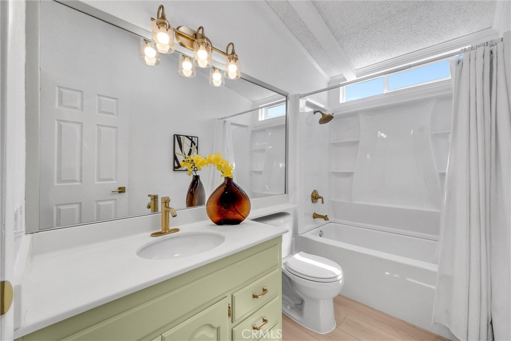 21650 Temescal Canyon Road, Unit 26 Corona, CA 92883 - Photo 23 of 32 a bathroom with a sink a toilet and shower