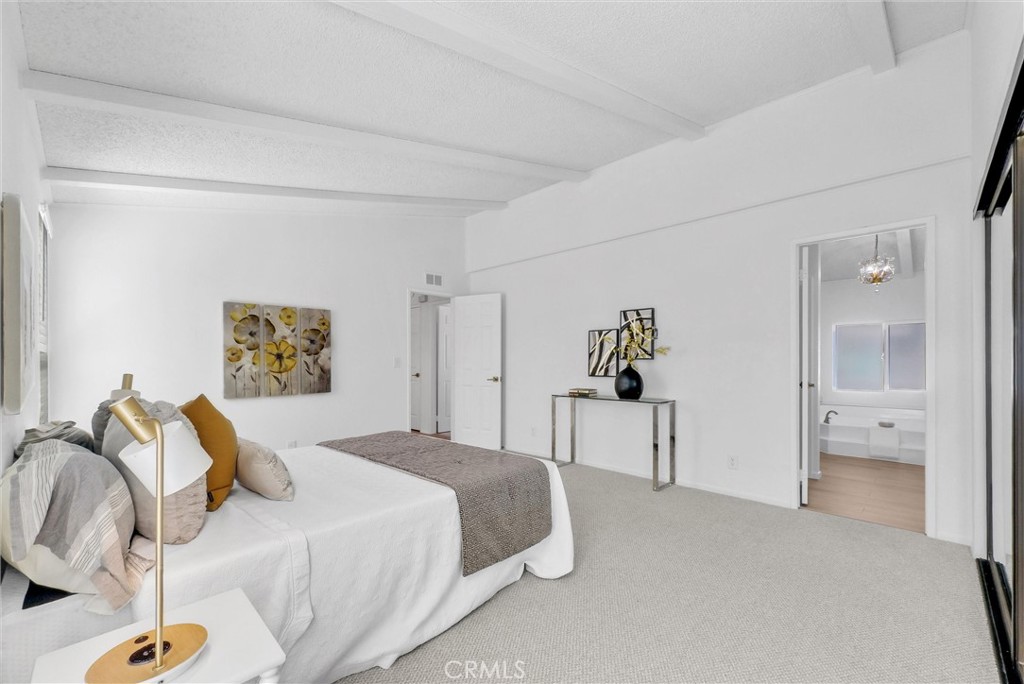 21650 Temescal Canyon Road, Unit 26 Corona, CA 92883 - Photo 25 of 32 a bedroom with a bed and a chandelier