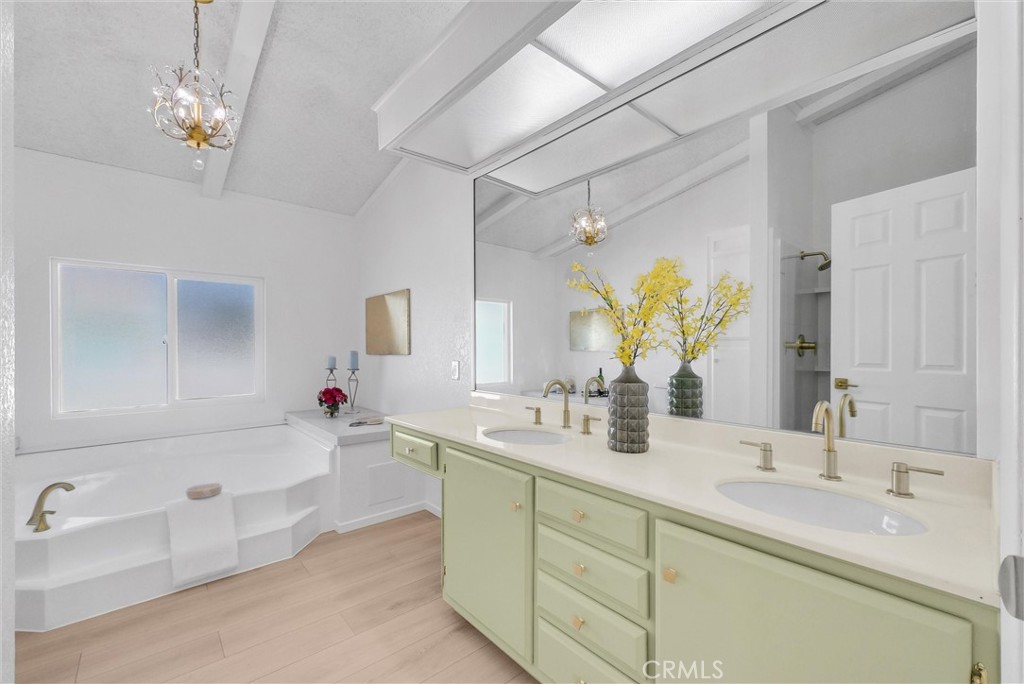 21650 Temescal Canyon Road, Unit 26 Corona, CA 92883 - Photo 26 of 32 a bathroom with a tub sink and mirror