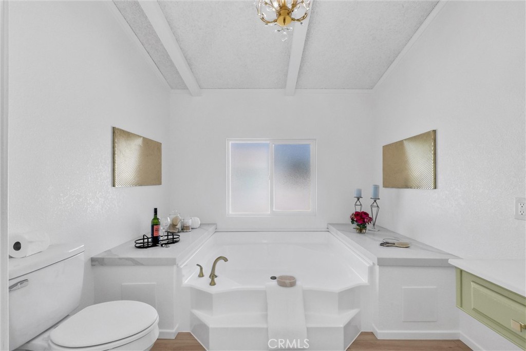 21650 Temescal Canyon Road, Unit 26 Corona, CA 92883 - Photo 27 of 32 a bathroom with a sink and a toilet