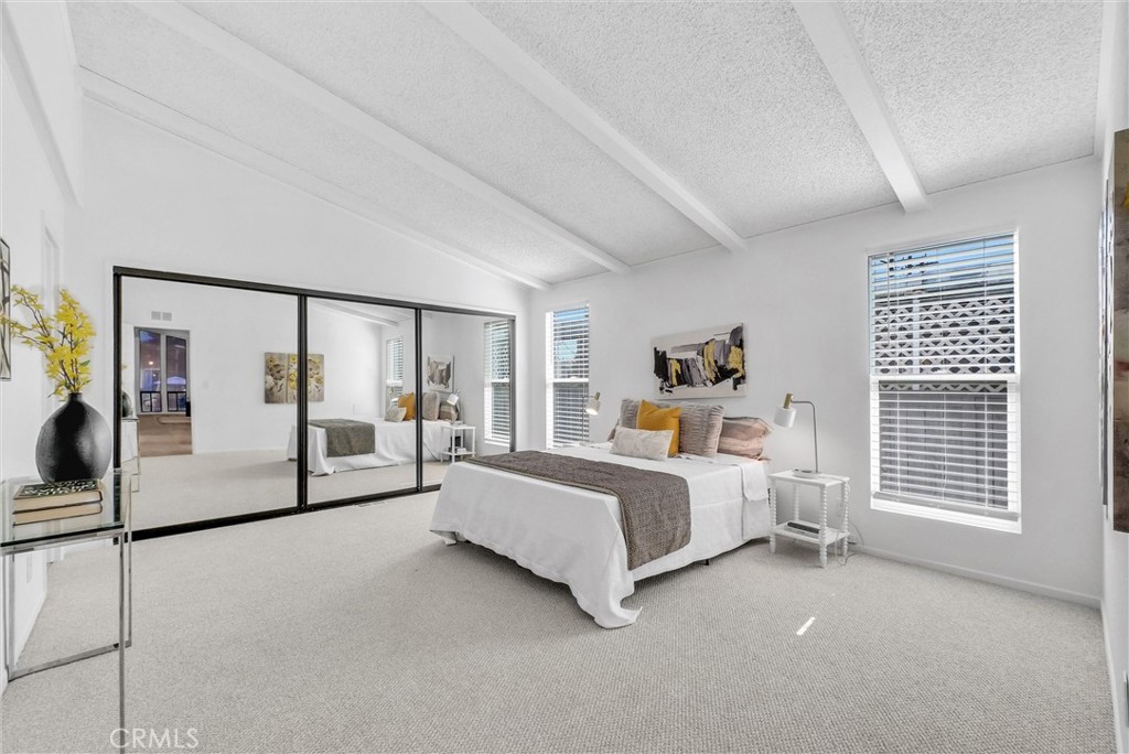 21650 Temescal Canyon Road, Unit 26 Corona, CA 92883 - Photo 3 of 32 a spacious bedroom with a bed and large window