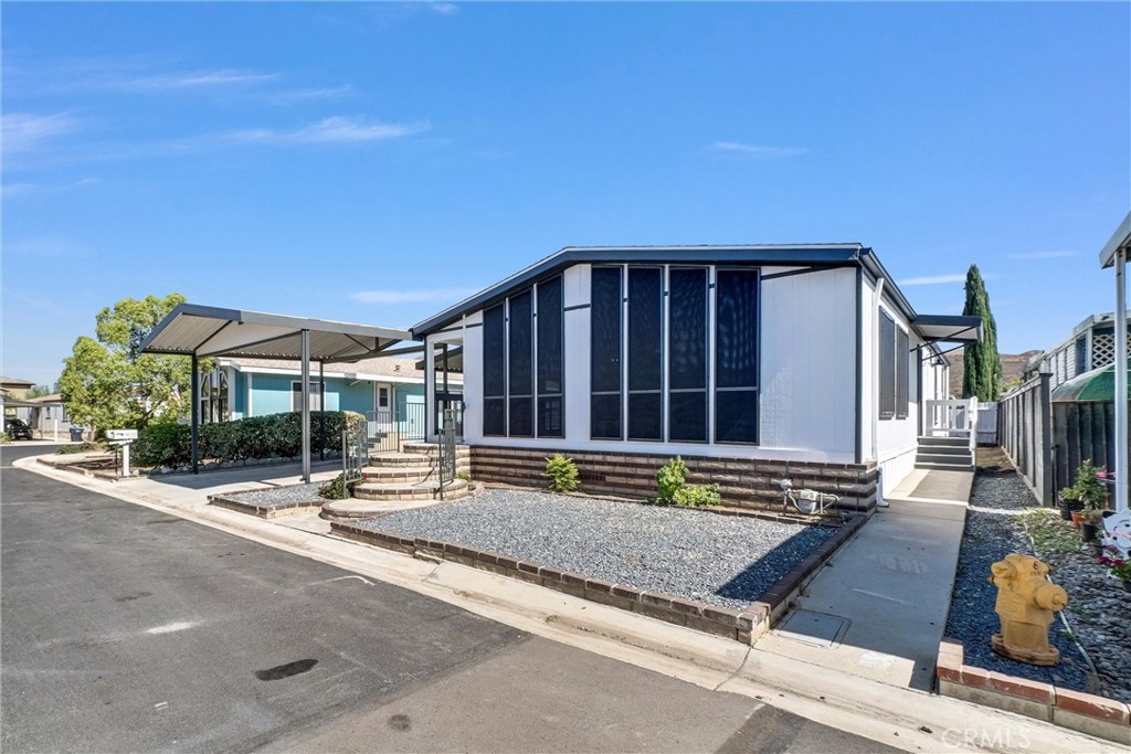 21650 Temescal Canyon Road, Unit 26 Corona, CA 92883 - Photo 7 of 32 a view of a building with sitting area