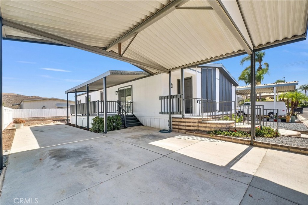 21650 Temescal Canyon Road, Unit 26 Corona, CA 92883 - Photo 8 of 32 a view of a house with a patio