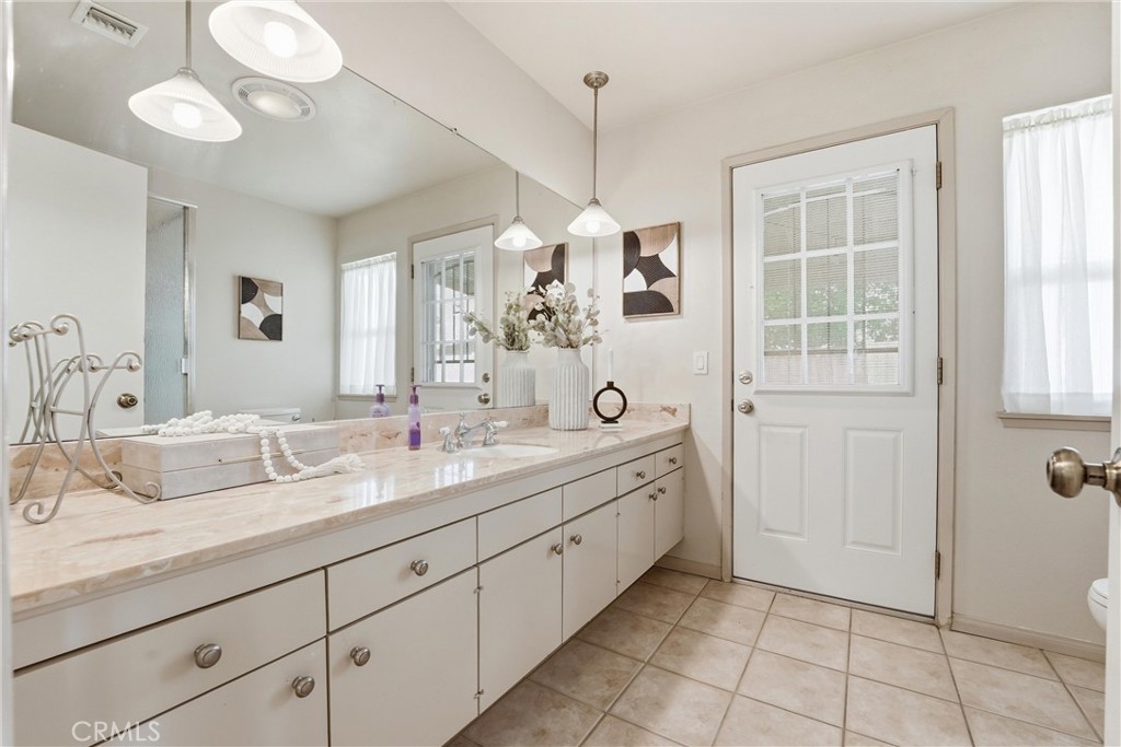 544 Firethorne Street Brea, CA 92821 - Photo 21 of 39 Primary Bathroom vanity is oversized and offers plenty of storage plus lots of natural light and a door that opens to the backyard!