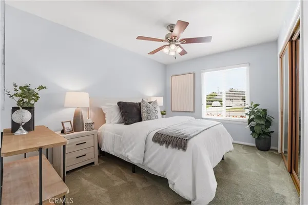 a spacious bedroom with a bed and a chandelier