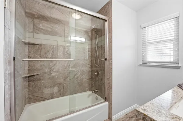 a bathroom with a bathtub and shower