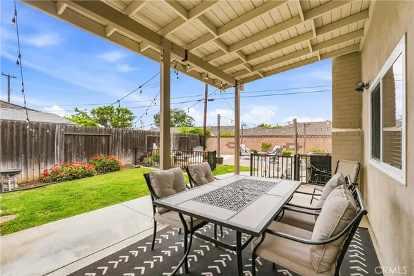 a view of a patio with a table chairs and a backyard