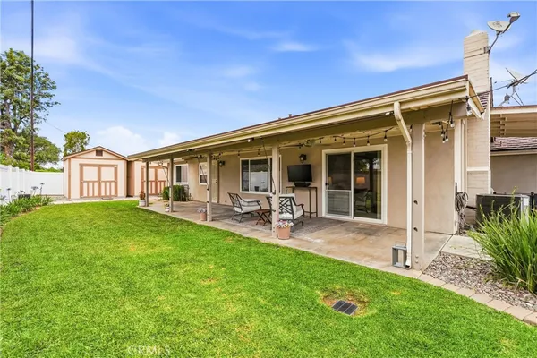 a view of a house with backyard porch and sitting area