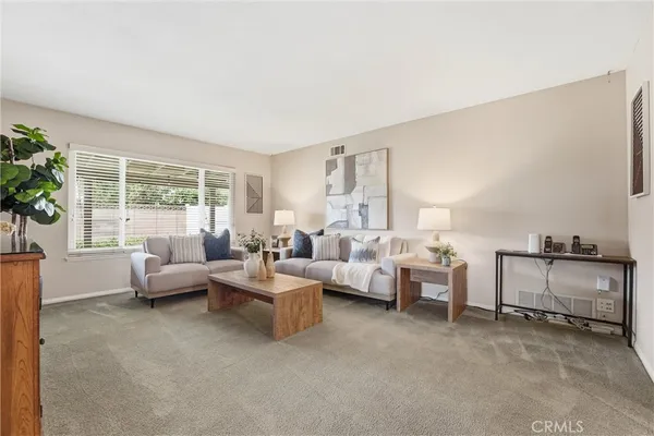 a living room with furniture and a large window