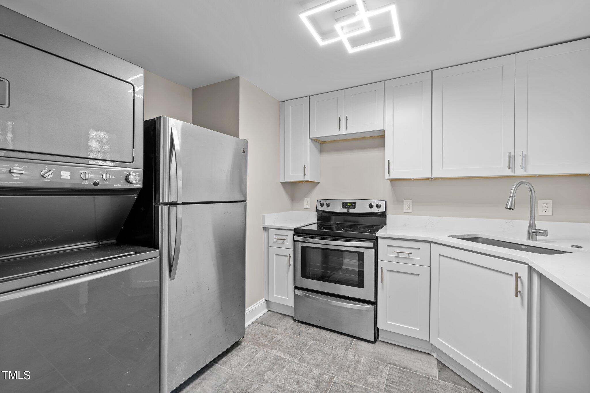 705 Bryan Street Raleigh, NC 27605 - Photo 4 of 42 a kitchen with stainless steel appliances a refrigerator sink and cabinets