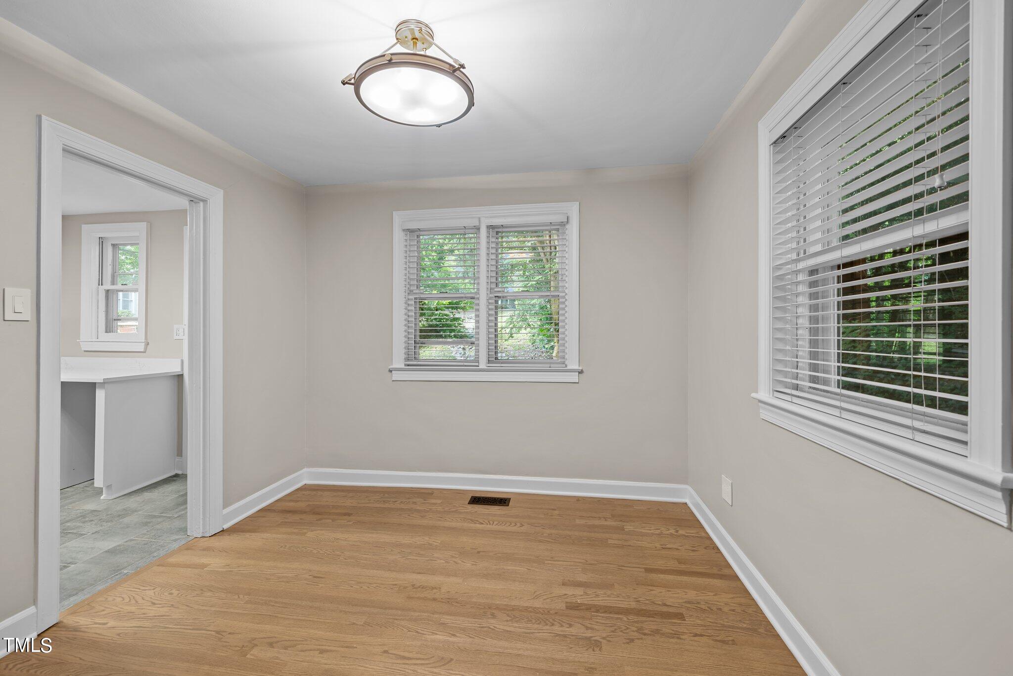 705 Bryan Street Raleigh, NC 27605 - Photo 6 of 42 a view of a room with wooden floor and window