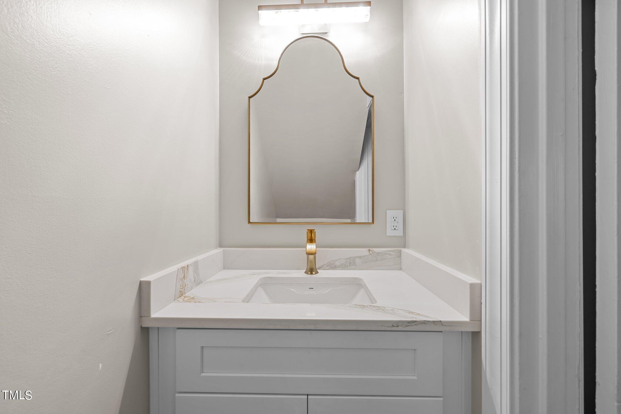 705 Bryan Street Raleigh, NC 27605 - Photo 7 of 42 a bathroom with a sink and a mirror