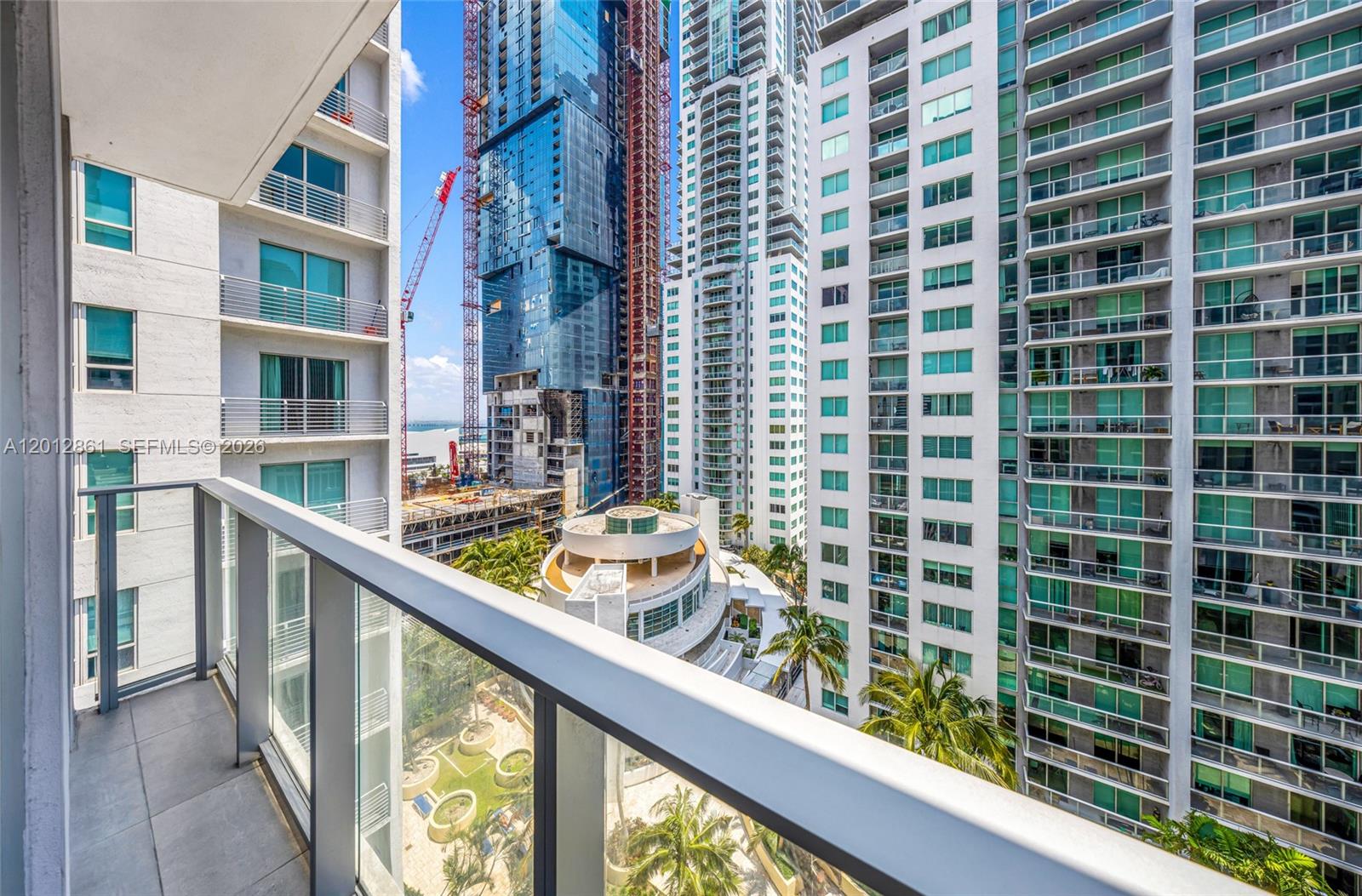 227 Northeast 2nd Street, Unit 1909 Miami, FL 33132 - Photo 7 of 18 a view of balcony with a couple of cars parked in front of it