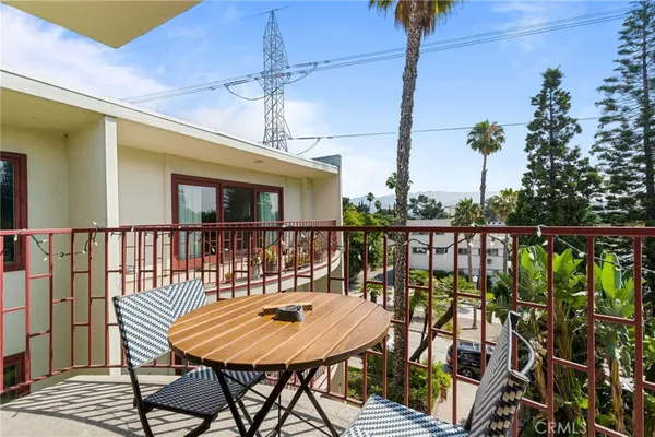 a balcony with table and chairs