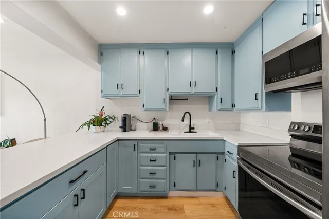 a kitchen with a sink stove and cabinets
