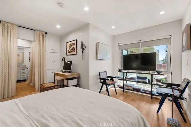 a bedroom with a bed and a flat screen tv