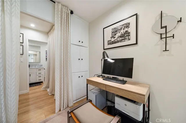 a view of room with cabinet and wooden floor