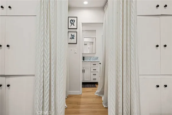 a view of a hallway with wooden shelves