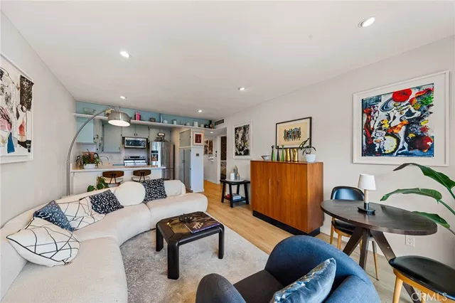 a living room with furniture and a flat screen tv with bookshelf