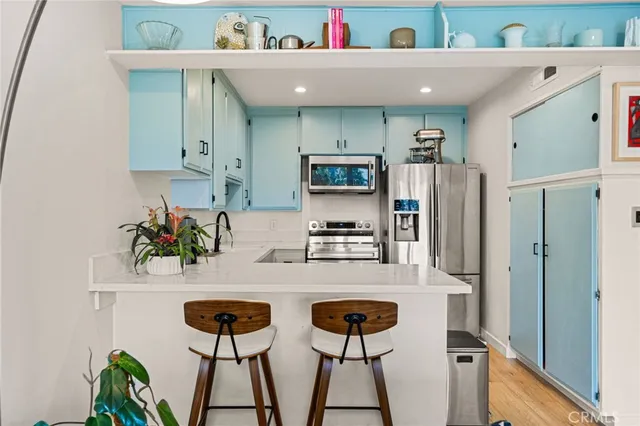 a kitchen with stainless steel appliances a sink and a refrigerator