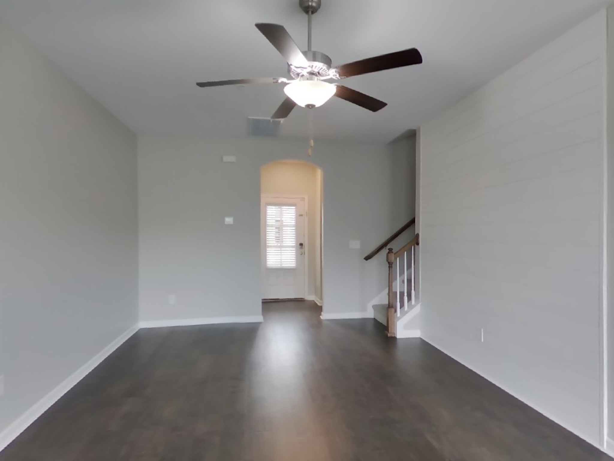 704 Finse Drive Spring Hill, TN 37174 - Photo 2 of 16 an empty room with wooden floor chandelier fan and windows