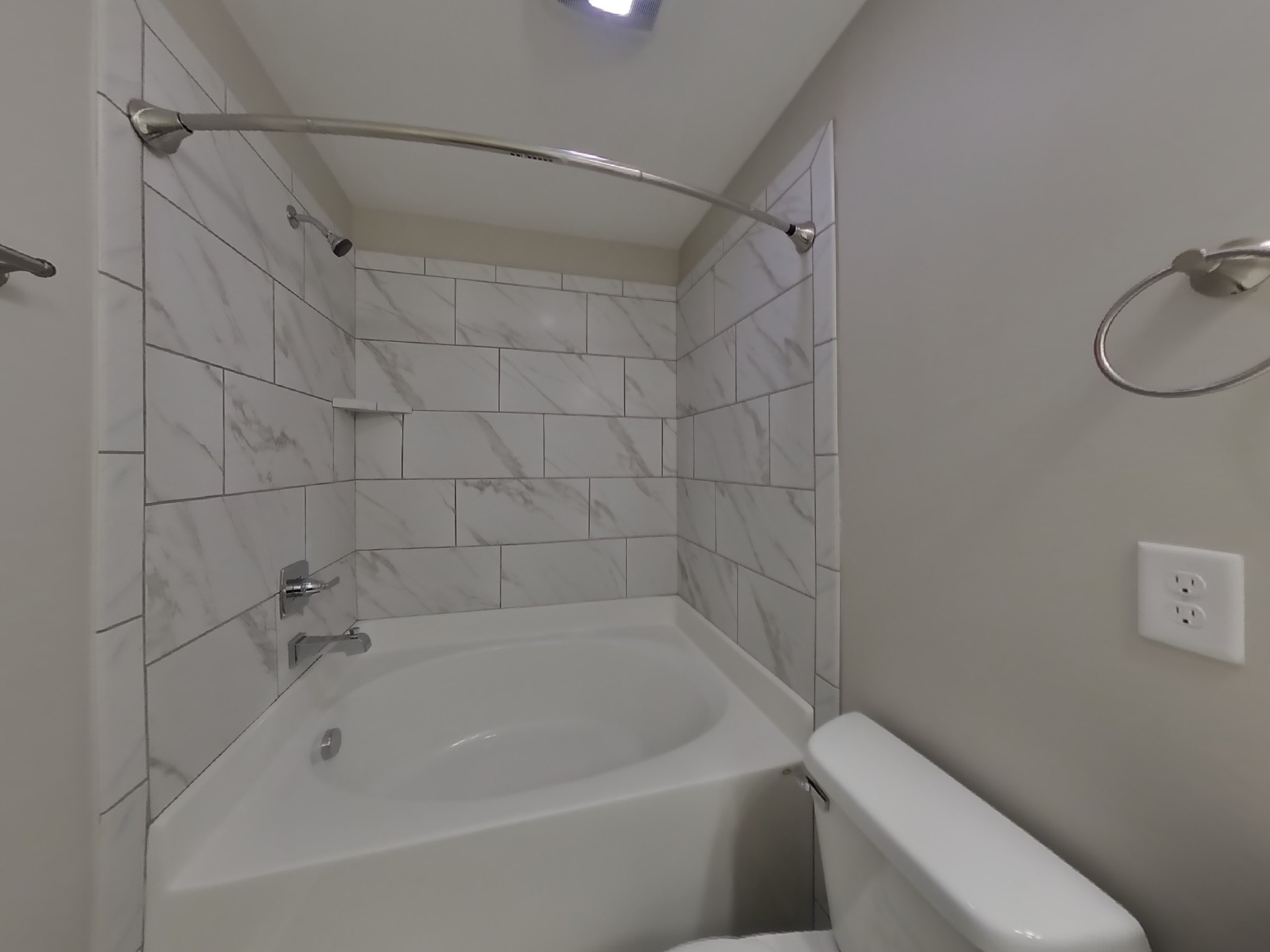 704 Finse Drive Spring Hill, TN 37174 - Photo 9 of 16 a white bath tub sitting next to a white toilet and a shower