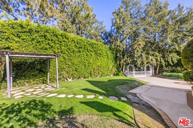 a view of a backyard with large trees