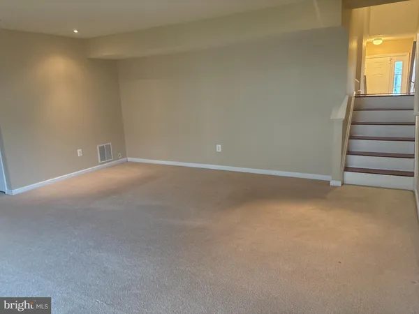 a view of an empty room with stairs