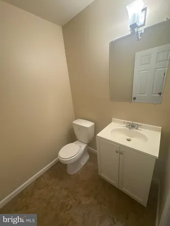 a bathroom with a sink a toilet and mirror