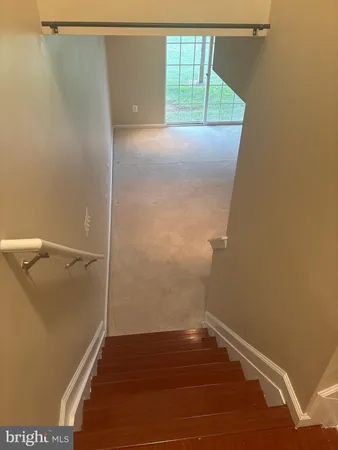 a view of a small space with wooden floor and cabinet