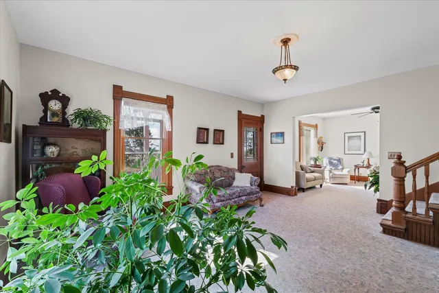 a living room with furniture gym equipment and a window