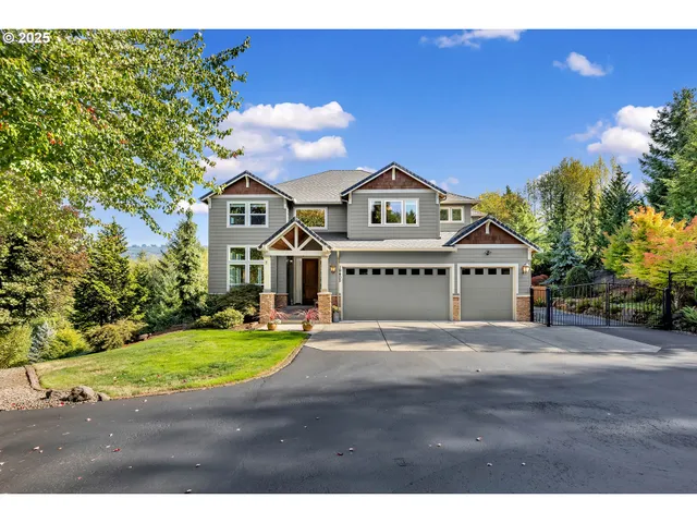 a view of a house with a big yard and large trees