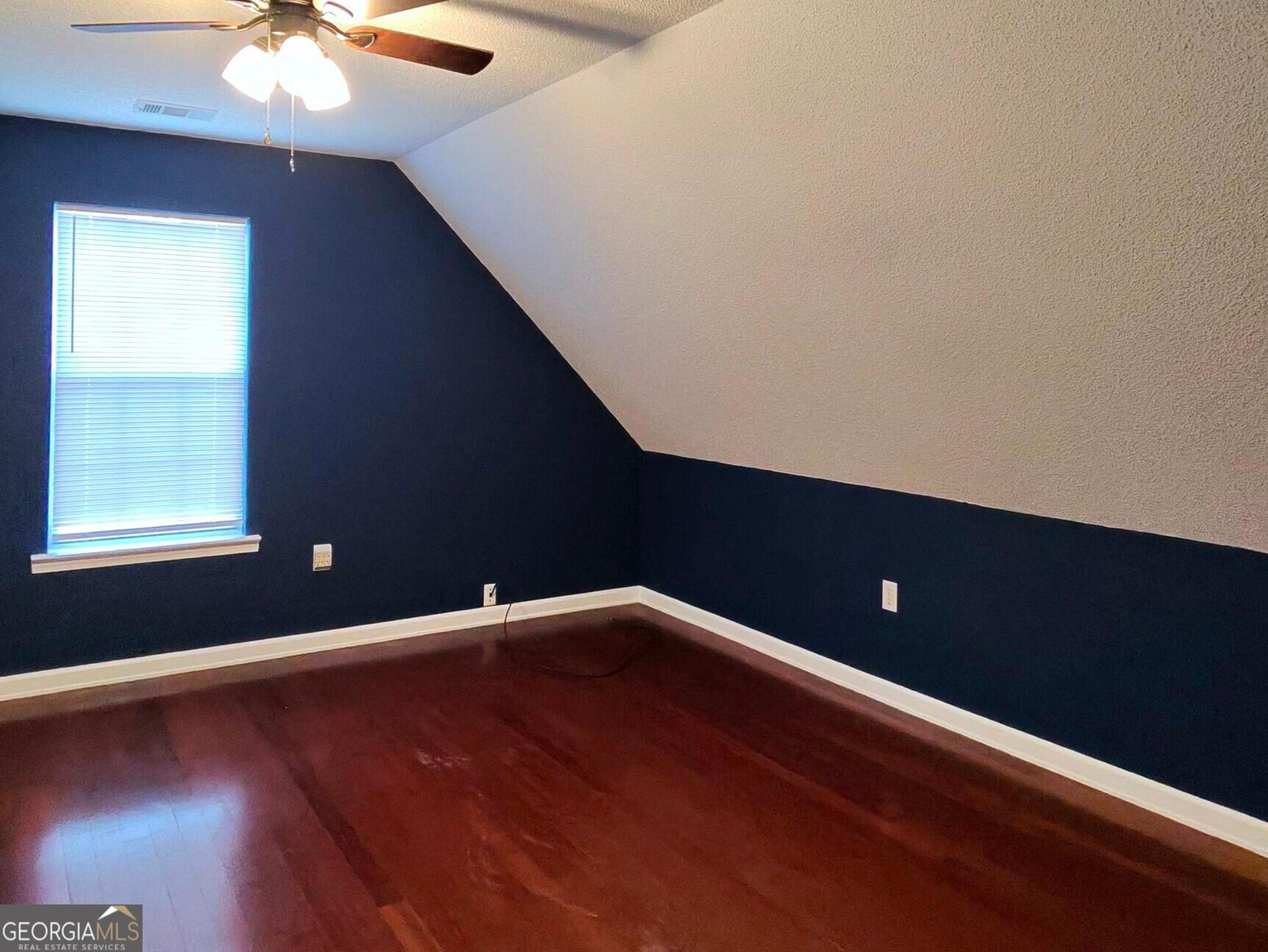 173 Preston Road Byron, GA 31008 - Photo 14 of 22 an empty room with wooden floor and windows