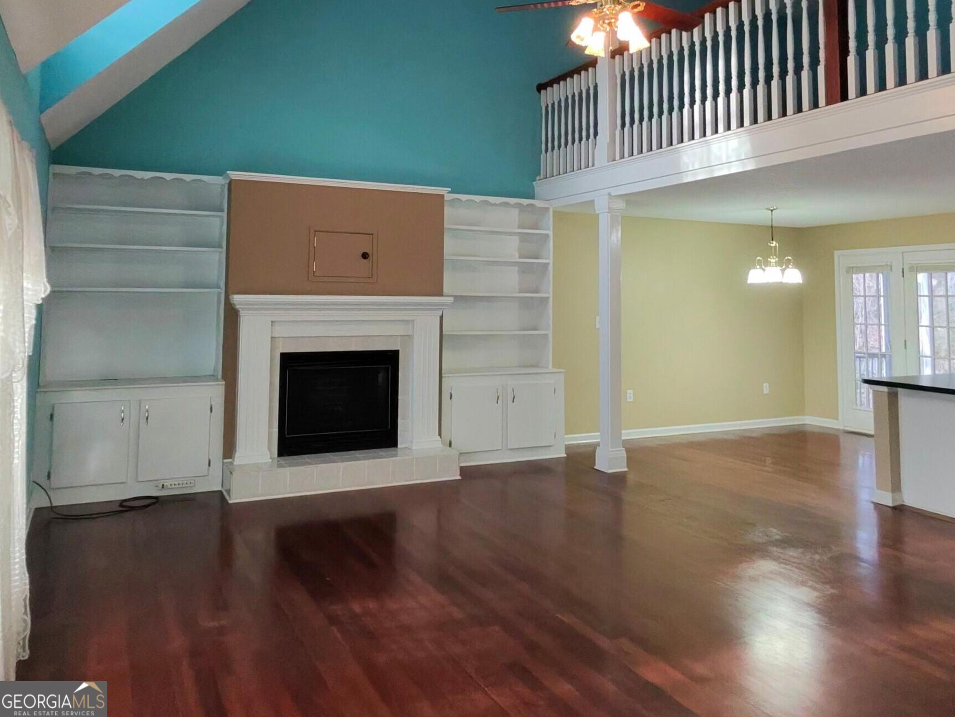 173 Preston Road Byron, GA 31008 - Photo 7 of 22 a view of a livingroom with wooden floor and a fireplace