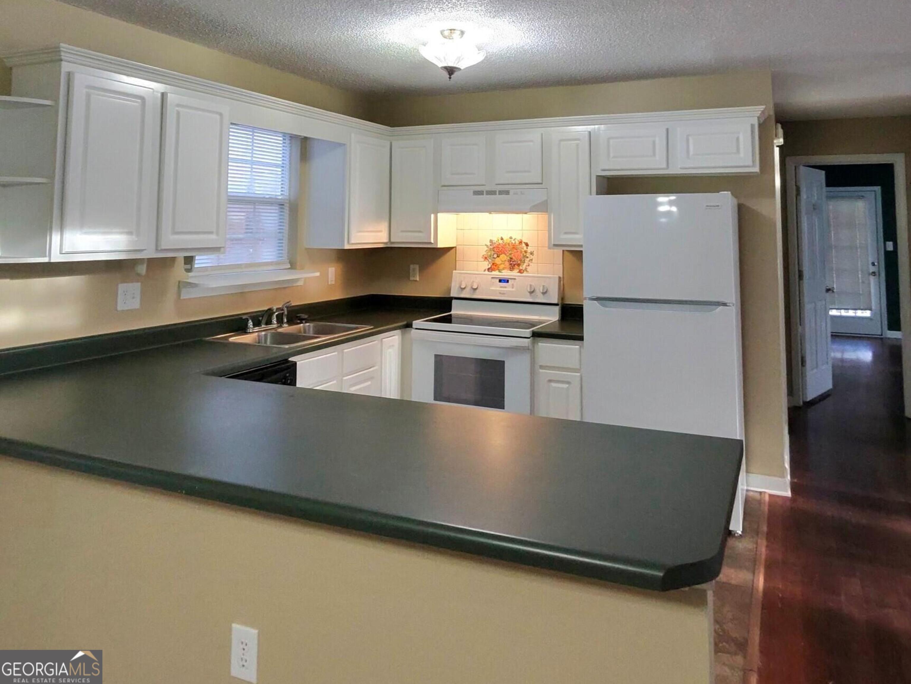 173 Preston Road Byron, GA 31008 - Photo 9 of 22 a kitchen with stainless steel appliances a refrigerator sink and cabinets