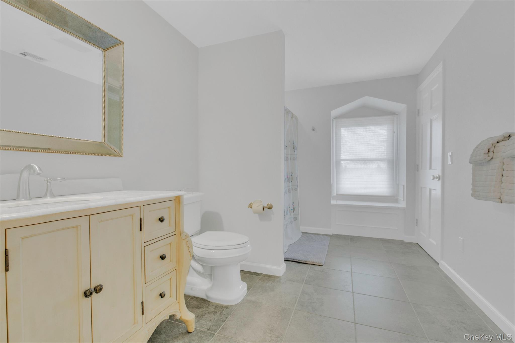 345 Colonial Road Southold, NY 11971 - Photo 25 of 31 a bathroom with a sink toilet and vanity