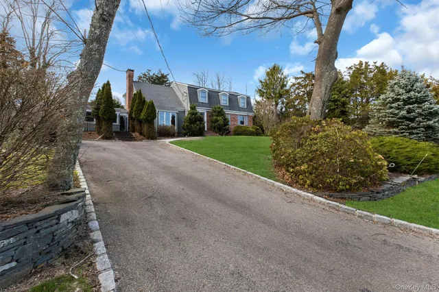 a view of a house with a yard and pathway