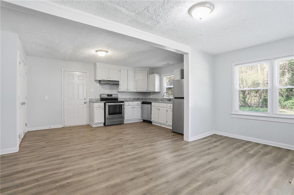 714 Reed Street Monroe, GA 30655 - Photo 11 of 31 a view of kitchen with wooden floor and electronic appliances