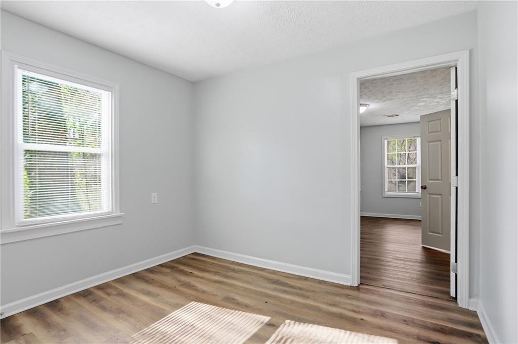 714 Reed Street Monroe, GA 30655 - Photo 15 of 31 an empty room with wooden floor and windows