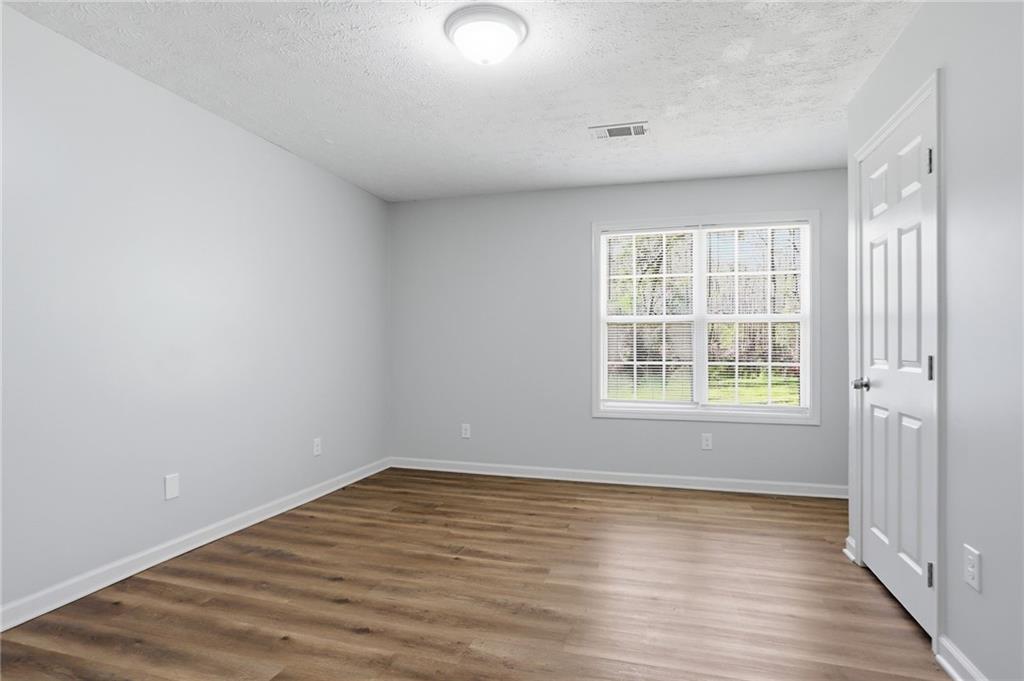 714 Reed Street Monroe, GA 30655 - Photo 18 of 31 wooden floor in an empty room with a window