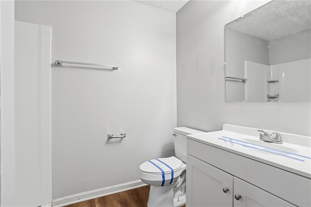 714 Reed Street Monroe, GA 30655 - Photo 22 of 31 a bathroom with a granite countertop toilet sink and mirror